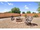 Backyard featuring a cozy fire pit surrounded by chairs and lush greenery at 2738 E Silversmith Trl, San Tan Valley, AZ 85143