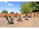 Backyard with a central firepit circled by seating, set in a gravel landscape at 2738 E Silversmith Trl, San Tan Valley, AZ 85143