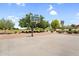 Outdoor basketball court featuring mature trees and landscaping in a well maintained community park at 2738 E Silversmith Trl, San Tan Valley, AZ 85143