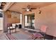 Cozy covered patio featuring ceiling fan, neutral paint, and sliding glass door access to home at 2738 E Silversmith Trl, San Tan Valley, AZ 85143