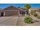Charming single-story home showcasing a two-car garage, gravel landscaping, and a tile roof at 2738 E Silversmith Trl, San Tan Valley, AZ 85143