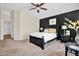 Main bedroom with black accent wall, ceiling fan, and ensuite access at 2738 E Silversmith Trl, San Tan Valley, AZ 85143