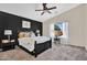 Main bedroom with black accent wall, ceiling fan, and neutral carpet at 2738 E Silversmith Trl, San Tan Valley, AZ 85143