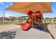 Community playground with slides and climbing structures under a shade canopy at 2738 E Silversmith Trl, San Tan Valley, AZ 85143