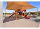 Community playground with slides and climbing structures under a shade canopy at 2738 E Silversmith Trl, San Tan Valley, AZ 85143