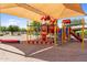 Community playground featuring modern structures under a large shade canopy at 2738 E Silversmith Trl, San Tan Valley, AZ 85143