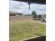 Large backyard featuring a sprawling lawn, brick fencing and a trampoline at 29474 W Columbus Ave, Buckeye, AZ 85396
