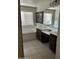 Bright bathroom featuring a soaking tub, dual sink vanity, and a large framed mirror at 29474 W Columbus Ave, Buckeye, AZ 85396