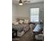 Cozy bedroom features a ceiling fan and natural light from the large window at 29474 W Columbus Ave, Buckeye, AZ 85396