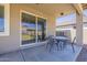 Covered patio area with a ceiling fan and sliding glass door access to the home's interior at 29474 W Columbus Ave, Buckeye, AZ 85396