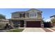 Charming two-story home featuring a well-manicured lawn, complemented by a spacious garage and inviting curb appeal at 29474 W Columbus Ave, Buckeye, AZ 85396