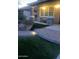 Inviting front entrance with stone accents, brick path and lush landscaping and well lit entryway at 29474 W Columbus Ave, Buckeye, AZ 85396