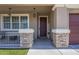 Inviting front porch with stone accents and decorative welcome sign by the front door at 29474 W Columbus Ave, Buckeye, AZ 85396