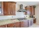 Close up on a kitchen featuring granite countertops, dark wood cabinets, and a gas cooktop at 29474 W Columbus Ave, Buckeye, AZ 85396
