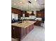 Spacious kitchen island with granite countertops and custom dark wood cabinetry at 29474 W Columbus Ave, Buckeye, AZ 85396