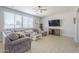 Cozy living room with plush sofa, neutral decor, and a large window for natural light at 29474 W Columbus Ave, Buckeye, AZ 85396