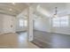 Open living room with wood-look floors, decorative ceiling beams, and bright natural light at 29474 W Columbus Ave, Buckeye, AZ 85396