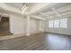 Spacious living room featuring wood-look floors and stylish lighting fixtures at 29474 W Columbus Ave, Buckeye, AZ 85396
