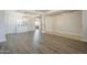 Open-concept living space with a modern hutch, wood-look floors, and neutral decor at 29474 W Columbus Ave, Buckeye, AZ 85396