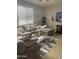 Comfortable living room features a large sectional sofa, stylish rug, and natural light from the large window at 29474 W Columbus Ave, Buckeye, AZ 85396