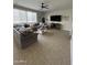 Spacious living room featuring tile floors, a large sectional sofa, and a bright window at 29474 W Columbus Ave, Buckeye, AZ 85396