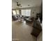 Inviting living room featuring neutral tones, tile floors, large sofa, and lots of natural light at 29474 W Columbus Ave, Buckeye, AZ 85396