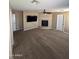 Cozy living room featuring carpet, fireplace, and neutral tones at 29474 W Columbus Ave, Buckeye, AZ 85396