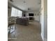Bright living room with tile floors, a large sectional sofa, a dining table and a ceiling fan at 29474 W Columbus Ave, Buckeye, AZ 85396