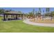 Neighborhood playground with swings, slides and picnic tables, under a shade structure at 29474 W Columbus Ave, Buckeye, AZ 85396