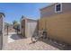 Side yard with paver stones, shed, and bike rack, enclosed by a block wall and iron gate at 29474 W Columbus Ave, Buckeye, AZ 85396
