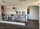 Cozy staircase landing featuring dark wood floors and an eye-catching wrought iron railing design at 29474 W Columbus Ave, Buckeye, AZ 85396