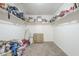 Large walk-in closet with ample shelving and storage space, and a chest of drawers at 29474 W Columbus Ave, Buckeye, AZ 85396