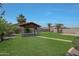 Expansive backyard featuring a charming gazebo, well-maintained lawn, and mature trees for outdoor enjoyment at 30308 W Whitton Ave, Buckeye, AZ 85396