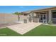 Relaxing backyard complete with a built-in outdoor kitchen, patio, and lush green grass at 30308 W Whitton Ave, Buckeye, AZ 85396