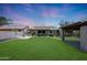 Lush backyard features an outdoor kitchen, a gazebo, and a well-manicured lawn, creating a serene retreat at 30308 W Whitton Ave, Buckeye, AZ 85396