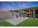 Beautiful backyard with a built-in barbecue, covered patio, and lush lawn, perfect for outdoor activities at 30308 W Whitton Ave, Buckeye, AZ 85396