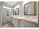 Modern bathroom showcasing a double sink vanity, granite countertops, and a sleek glass enclosed shower at 30308 W Whitton Ave, Buckeye, AZ 85396