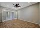 This bedroom features recessed lighting, a ceiling fan, and double doors at 30308 W Whitton Ave, Buckeye, AZ 85396