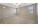 Spacious bedroom featuring stylish tile flooring, ceiling fan, and neutral paint, providing a serene atmosphere at 30308 W Whitton Ave, Buckeye, AZ 85396