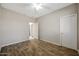 Empty bedroom featuring wood-look floors, a ceiling fan, and a closet at 30308 W Whitton Ave, Buckeye, AZ 85396