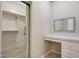 Customized closet with ample storage, vanity area, modern mirror, and abundant shelving and racks at 30308 W Whitton Ave, Buckeye, AZ 85396