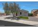 Well-maintained front yard featuring a mature tree and gravel landscaping at 30308 W Whitton Ave, Buckeye, AZ 85396