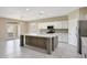 Spacious kitchen featuring white cabinets, a center island and stainless appliances at 30308 W Whitton Ave, Buckeye, AZ 85396