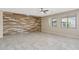 Spacious living room featuring stylish accent wall, tile flooring, and large windows for a bright interior at 30308 W Whitton Ave, Buckeye, AZ 85396