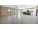 Open living space flows into kitchen with spacious floor plan and natural light, perfect for entertaining at 30308 W Whitton Ave, Buckeye, AZ 85396