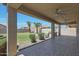 A covered patio overlooks a spacious backyard with lush landscaping, creating a serene outdoor oasis at 30308 W Whitton Ave, Buckeye, AZ 85396