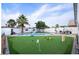Well-maintained backyard featuring a pool, artificial turf with golf equipment and a relaxing atmosphere at 3224 E Desert Cove Ave, Phoenix, AZ 85028
