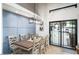 Dining room with large glass doors leading to the outdoor space, a stylish chandelier, and seating for six at 3224 E Desert Cove Ave, Phoenix, AZ 85028