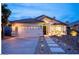 Charming home exterior with a two-car garage, well-lit pathway, and manicured landscaping at 3224 E Desert Cove Ave, Phoenix, AZ 85028