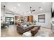 Open-concept living room with modern lighting, comfortable sofa, and seamless transition to the kitchen at 3224 E Desert Cove Ave, Phoenix, AZ 85028